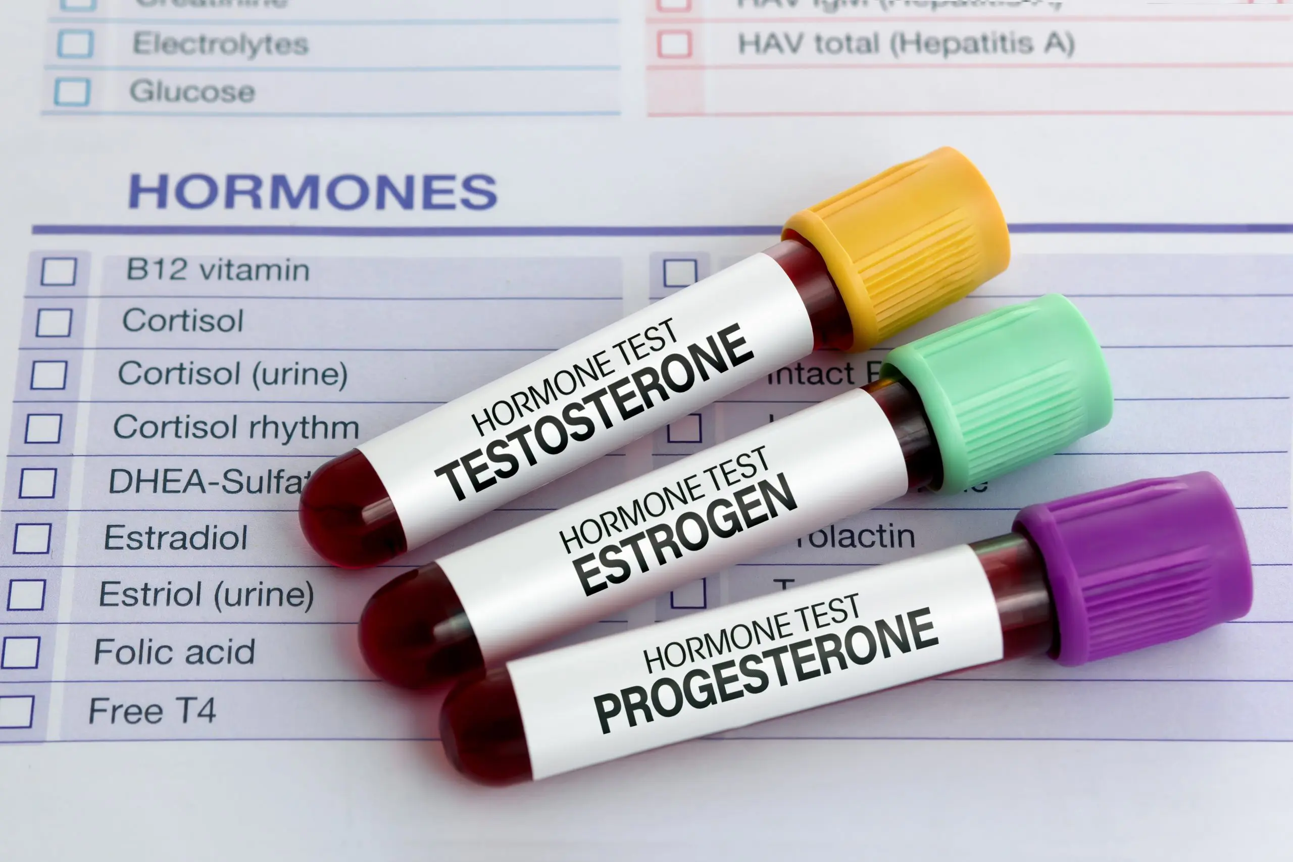 Harmony Hormone Solutions - Three test tubes labeled "Testosterone," "Estrogen," and "Progesterone" on a hormone test chart.